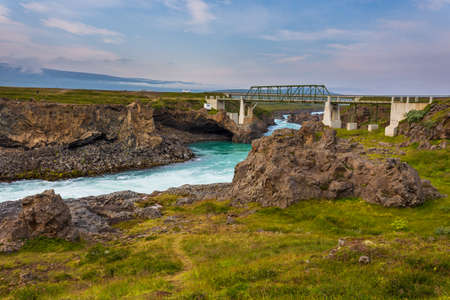 The milky blue waters of the Skjalfandafljot River that form the Godafoss Waterfall, which flows from the northern face of Vatnajokull Glacier.の写真素材