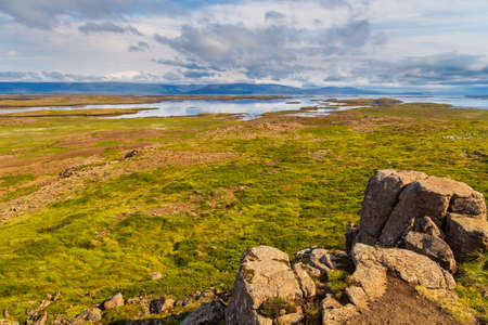 View of the Hvammsfjordur coast, hills in the background, eastern Iceland.の写真素材