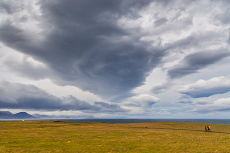 Arnarstapi, Iceland- 26 August 2015: People walking on the south coast of the Snaefellsnes peninsula. Western Iceland.のeditorial素材
