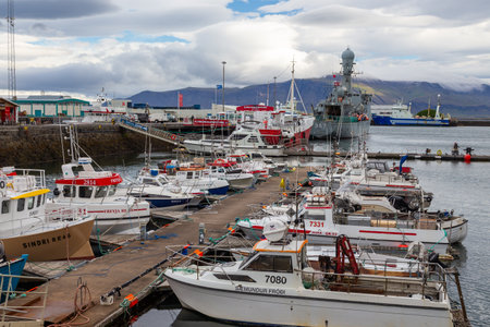 Reykjavik, Iceland- 27 August 2015: Port buildings and moored boats in the capital town. Mountain in the background.のeditorial素材