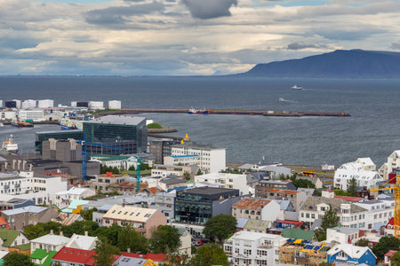 Reykjavik, Iceland- 27 August 2015: Panoramic view of the city of Reykjavik from Hallgrimskirkja tower. Mountain in the background.のeditorial素材