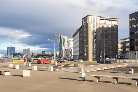 Reykjavik, Iceland- 27 August 2015: Modern buildings in capital city at Midborg street. Facade of skyscrapers during construction.のeditorial素材