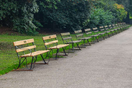 Several benches near the pond in Battersea Park during autumn season in Londoonの写真素材