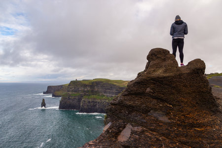 Cliffs of Moher, Burren Way, Ireland- 07 November 2015: People walking and staying at the cliffs of...