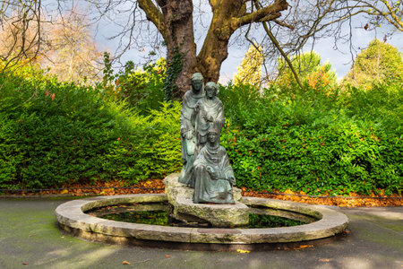 Dublin, Ireland - November 10, 2015: A fountain in Saint Stephen Green Park with a sculpture, a portrait of three women. Park is original Victorian style.のeditorial素材