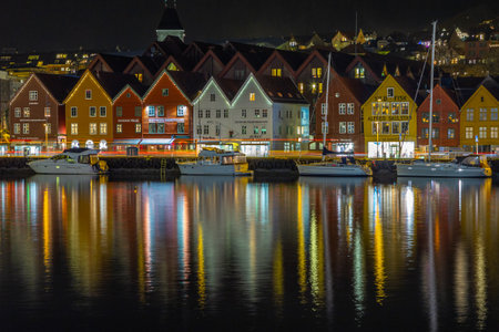 Bergen, Norway- 12 December 2015: View of the Bryggen, series of Hanseatic heritage commercial buildings lining up the eastern side of Vagen harbor at night. Beautiful illumination.のeditorial素材