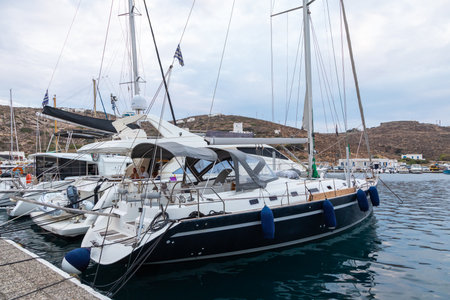 Paralia Gialos, Ios Island, Greece- 19 September 2020: Boats and sailing ship moored at the harbor...