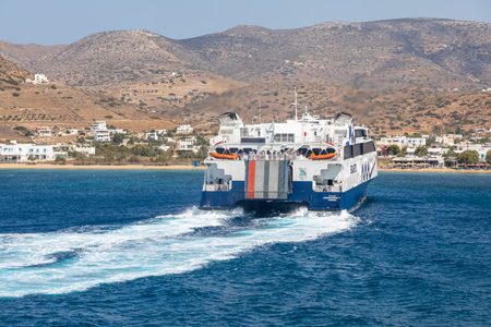 Chora, Ios Island, Greece- 22 September 2020: View of the Harbor of Ios. Passenger ferry departing harbor.のeditorial素材