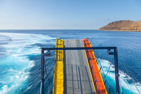 The ferry enters the port on the island of Sikinos while opening the hatch. Sikinos Island, Greece.の写真素材