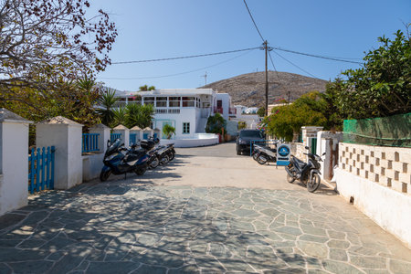 Folegandros Island, Greece - 23 September 2020: A narrow side street in Chora, old town. Characteristic Greek buildings, vehicles parked along.のeditorial素材