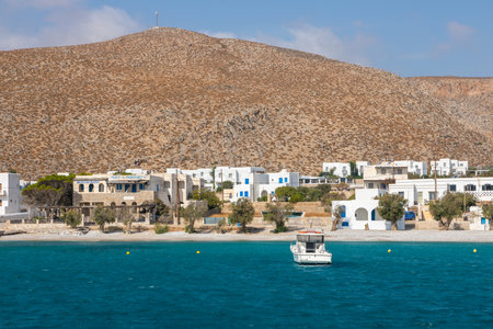 Folegandros Island, Greece - 24 September 2020: View of the small port town on the island of Folegandros. White villas on the hill of the island, boat in the waters of the bay.のeditorial素材