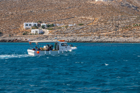 Folegandros Island, Greece - 24 September 2020: View of the small port town on the island of Folegandros. White villas on the hill of the island, boat in the waters of the bay.のeditorial素材