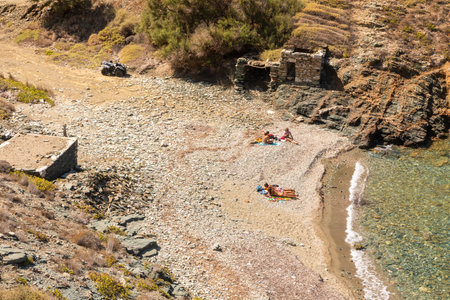 Folegandros Island, Greece - 25 September 2020: View of the coast and Ligaria beach of the island of Folegandros. People are sunbathing on the beach. Aegean Sea, Cyclades Archipelago.のeditorial素材