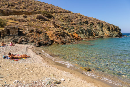 Folegandros Island, Greece - 25 September 2020: View of the coast and Ligaria beach of the island of Folegandros. People are sunbathing on the beach. Aegean Sea, Cyclades Archipelago.のeditorial素材