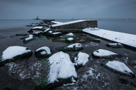 Concrete breakwater covered with snow. Winter season. Gdanska Bay, Poland.の写真素材