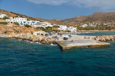 Sikonos, Greece- 26 September 2020: View of the harbor of Sikinos Island. People waiting for the ferry. Traditional white building on the hills.のeditorial素材