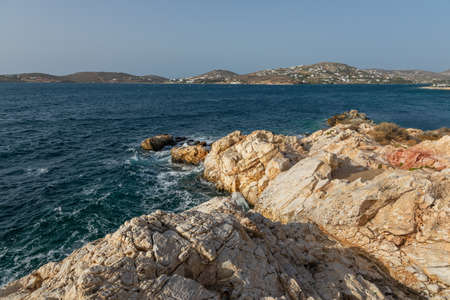 View of the port with traditional buildings on the hills in the background. Paros, Greece.の写真素材