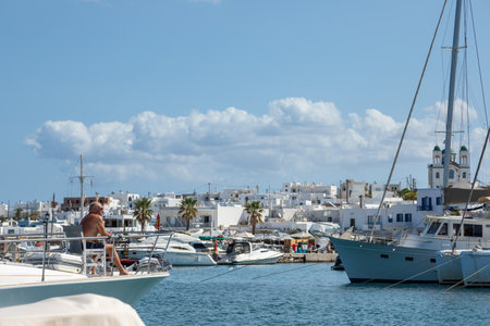 Naoussa, Paros Island, Greece - 27 September 2020: Boats and sailing ship moored at the harbor...