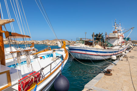 Naoussa, Paros Island, Greece - 27 September 2020: Boats and sailing ship moored at the harbor...