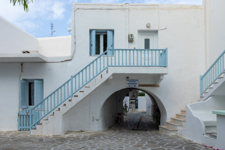 Antiparos Port, Antiparos Island, Greece - 28 September 2020: Narrow street of the old town. Traditional, withe architecture and a stone path with white joints.のeditorial素材