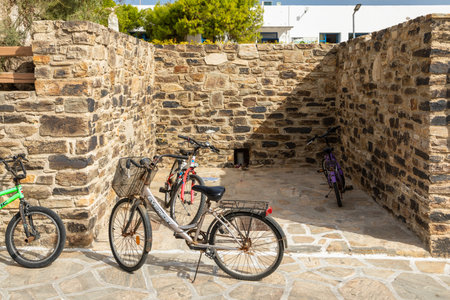 Antiparos Island, Greece - 28 September 2020: Bicycles parked along a narrow street on Antiparos Island. Summer season.のeditorial素材