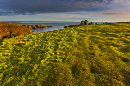 View of the ruins of the 13th century Dunnottar Castle, medieval fortress. Aberdeenshire, Stonehaven, Scotland, United Kingdom. Sunny morning.の写真素材