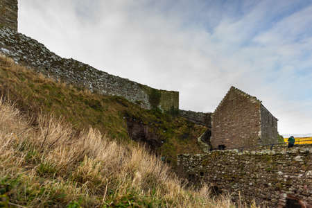 View of the ruins of the 13th century Dunnottar Castle, medieval fortress. Aberdeenshire, Stonehaven, Scotland, United Kingdom. Sunny morning.の写真素材