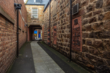 Peterhead, Scotland, UK - 05 February 2016: View of the buildings along narrow street in the city center, cloudy day. Pedestrian zone.のeditorial素材