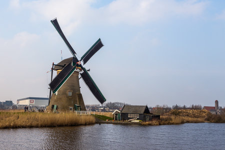 Kinderijk, Netherlands - 11 March 2016: View of the Famous windmills, Lek Canal and small pier. Vicinity of the museum UNESCO World Heritage Kinderdijk.のeditorial素材