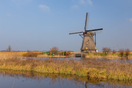 Kinderijk, Netherlands - 11 March 2016: View of the Famous windmills, Lek Canal and small pier. Vicinity of the museum UNESCO World Heritage Kinderdijk.のeditorial素材