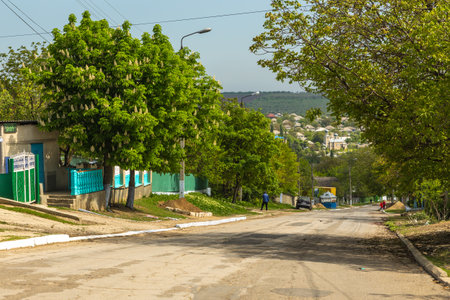 Cruglic, Republic of Moldova - 01 May 2016: Cars on a gravel road in a small village. Spring season rural landscape.のeditorial素材