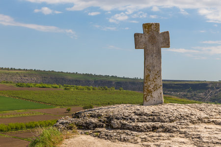 A view of the old cross at rock monastery Orheiul Vechi in Reut river valley in Trebujeni, natural landscape of limestone rock. Republic of Moldova.の写真素材