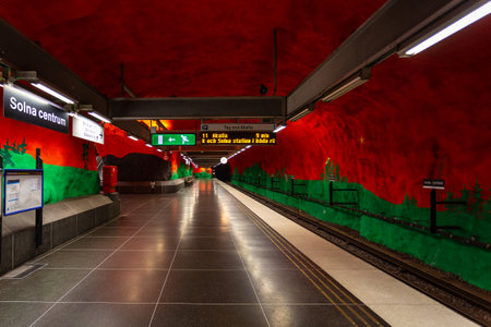 Stockholm, Sweden - June 25, 2016: Solna Centrum Station, metro station carved out of the rock. Red walls with painting.のeditorial素材