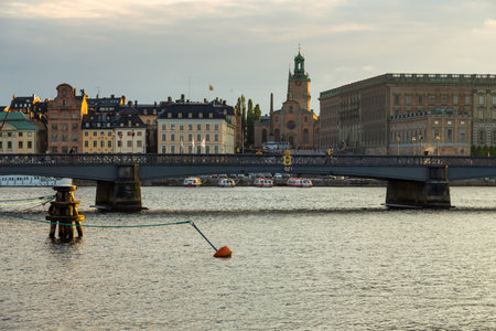 Stockholm, Sweden - May 29, 2016: View of the old town of Gamla Stan and bridge Gilded Crown on Skeppsholmsbron from the Sodra Blasieholmshamnen waterfront.のeditorial素材
