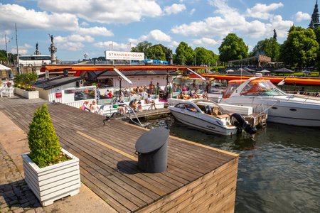 Stockholm, Sweden - June 25, 2016: Marina in the capital city of Stockholm. Passenger boats on the bay. Historic town.のeditorial素材