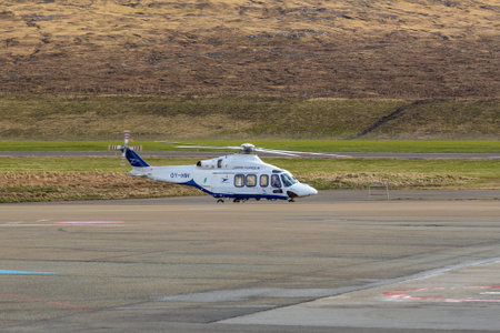 Sorvagur, Faroe Islands - 28 April 2018: View of the helicopter Atlantic Airways AgustaWestland AW139 OY-HIH on Vagar Airport. Hill in the background.のeditorial素材