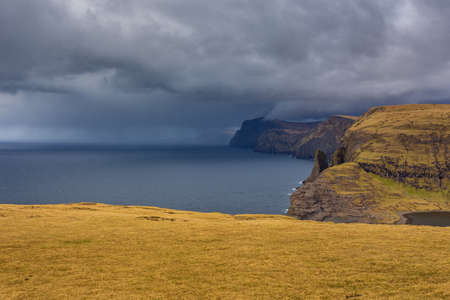 View of the coastline near Leitisvatn Lake above the Ocean. Walking area, peat field, and...
