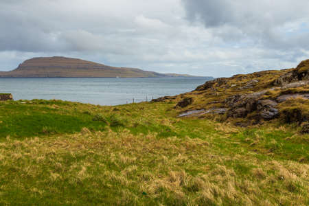 Steep coast of the island of Streymoy. Volcanic archipelago in the Atlantic Ocean, Thorshavn, Faroe...
