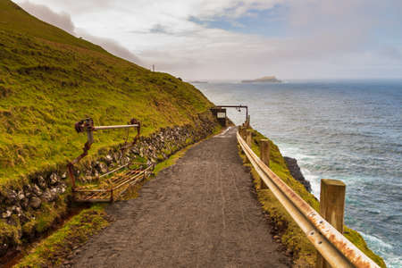View of the steep Atlantic Ocean coast on Vagar Island near Gasadalur. Faroe Islands.の写真素材