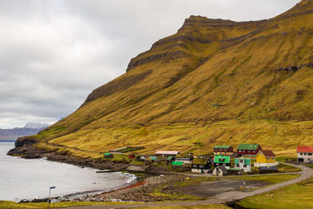 Small village Elduvik situated on the slope of the mountain on Eysturoy island. Faroe Islands, Denmark.の写真素材