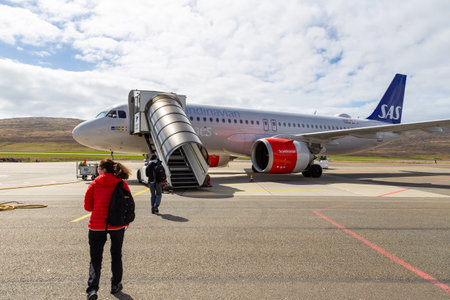 Sorvagur, Faroe Islands - 07 May 2018: Passengers boarding from a SAS airline. Vagar airport apron. Hills in the background.のeditorial素材