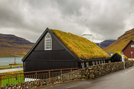 View of the Kollafjordur Church, Kirkja in small village on Streymoy island. Cloudy day. Kollafjordur, Faroe Islands. Denmark.のeditorial素材