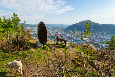 Bergen, Norway - 28 May 2018: People sitting on a bench on Floyen Hill. View of the city and the fjord in the background.のeditorial素材
