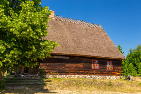 Wdzydze Kiszewskie, Poland - 31 May 2018: Thatched cottage in open-air museum, Kashubian Ethnographic Park.のeditorial素材