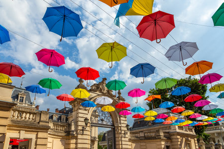 Lviv, Ukraine - 08 June 2018: Colorful umbrellas in the streets. Art object in old city of Lviv. Pedestrian street with bright decoration. Variety of multicolored umbrellas. Lviv cityscapeのeditorial素材