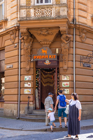 Lviv, Ukraine - 09 June 2018: Traditional buildings in a cobblestone street in historical Old town of Lviv. Entrance to the famous Red Cat cafe.のeditorial素材