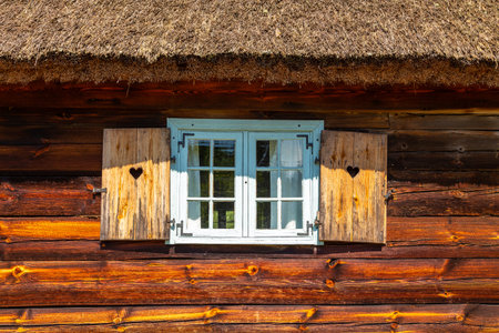 Thatched cottage with wooden shutters in open-air museum, Kashubian Ethnographic Park.のeditorial素材
