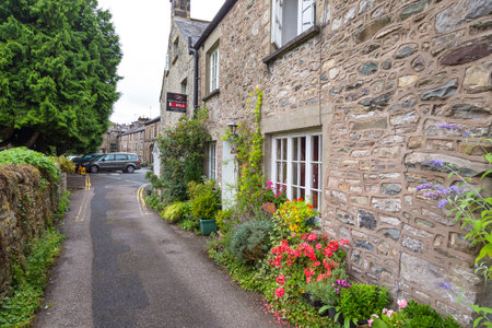 Kirkby Lonsdale, Cumbria, England - August 12, 2018: Narrow streets in the market town. Traditional stone houses.のeditorial素材