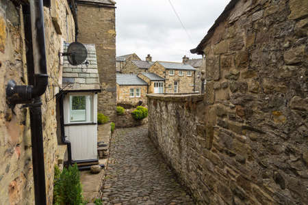 Narrow streets in the market town. Traditional stone houses. Kirkby Lonsdale, Cumbria, England.