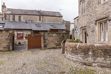 Kirkby Lonsdale, Cumbria, England - August 12, 2018: Narrow streets in the market town. Traditional stone houses.のeditorial素材